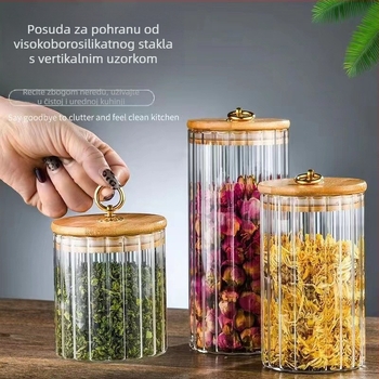 Prozirna staklena posuda za čaj velikog kapaciteta, okruglog oblika, s vertikalnim prugama i zatvaračem sa trakom za vuču.