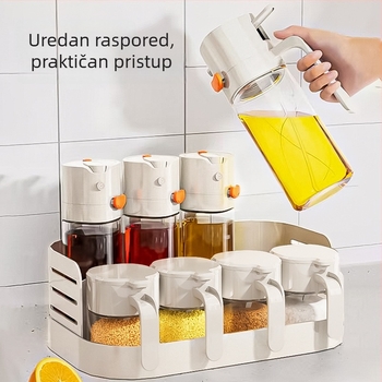 Dvostruki stalak za začine na kuhinjskom pultu s zatvorenim staklenkama ulja, soli, umaka i octa