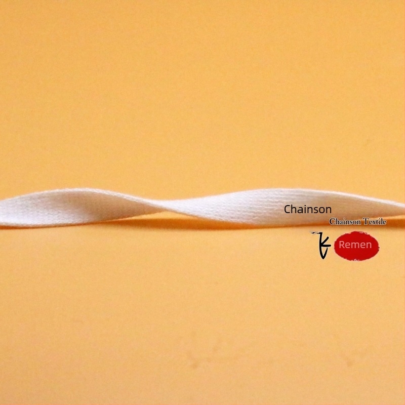 Elastična pletena traka od mercerisiranog pamuka, širine 1–4 cm, crno-bijela.