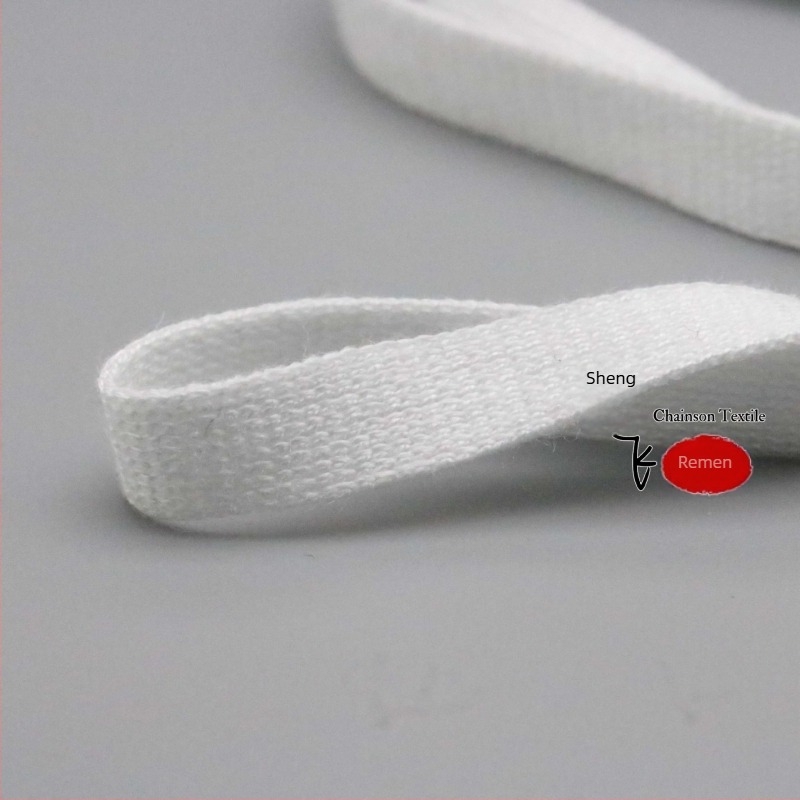Elastična pletena traka od mercerisiranog pamuka, širine 1–4 cm, crno-bijela.