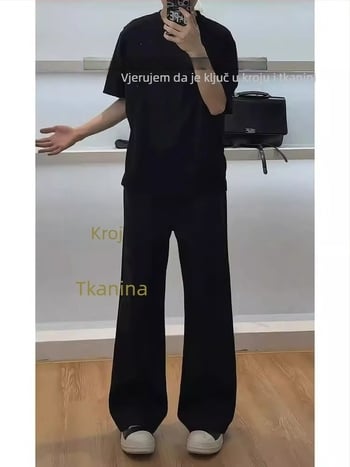 Crne muške hlače poslovnog stila s elegantnim drapanjem, čisti kroj, lagani ljetni materijal, ravni kroj uz blago proširenje nogavica