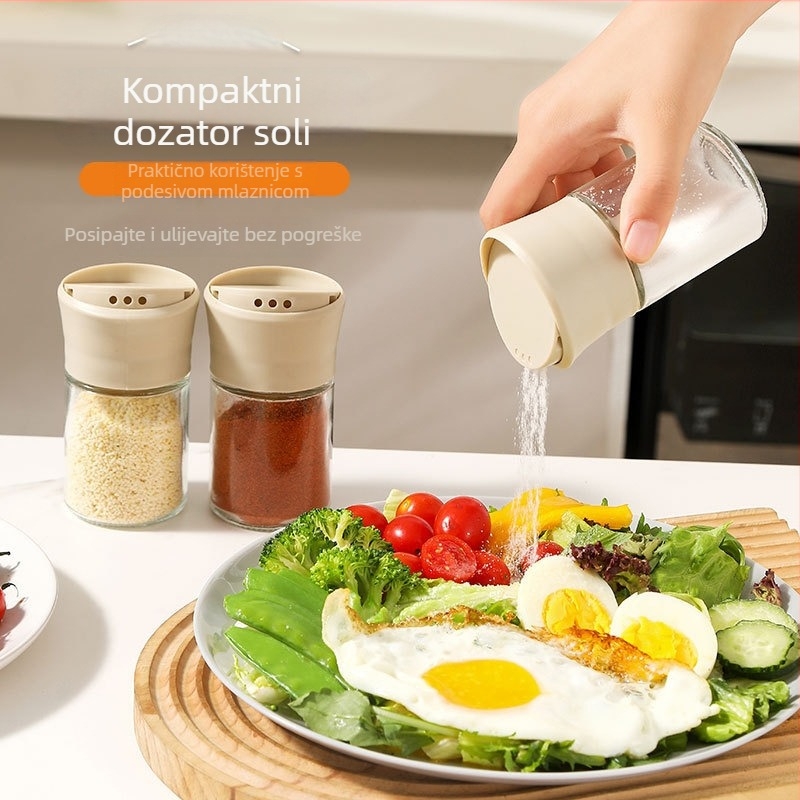 Zatvorena staklena posuda za začine s dozatorom za sol, kmín i papar