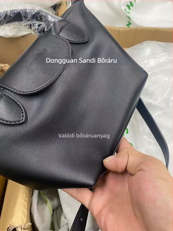 Valódi bőrből készült dumpling alakú táska fedéllel, vászon belső bélés, belső cipzáras zseb, telefontartó és személyi igazolvány zseb, egy vállpánt