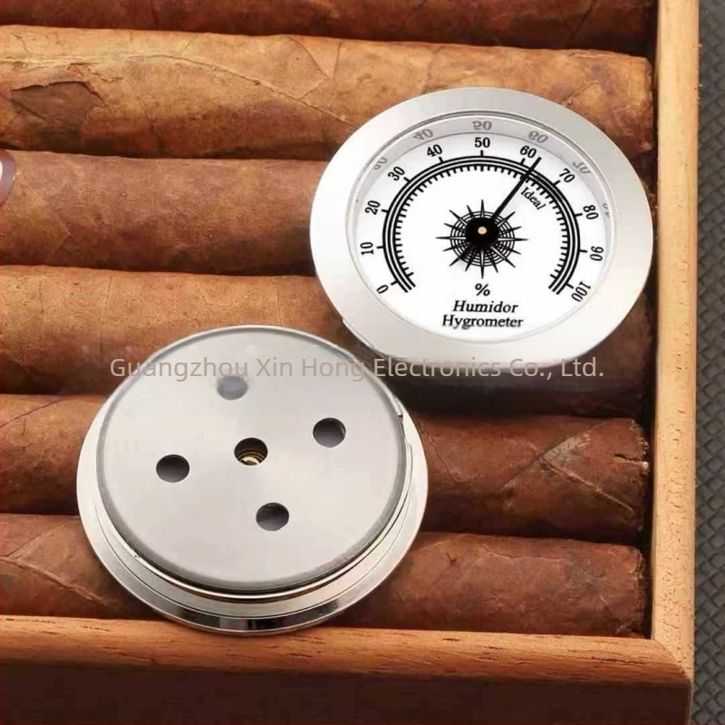 Pointeres hőmérséklet- és páratartalom-mérő humidorokhoz és hangszeres tokokhoz; páratartomány 0–100% RH; hőmérséklet-tartomány -30–60°C; páratartalom pontosság ±5%; hőmérséklet pontosság ±1°C.