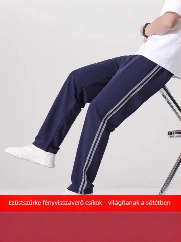 Tengerészkék melegítőnadrág egyenes szabásban, két csíkkal és fényvisszaverő részletekkel, uniszex diáknak szánt modell, ősz-téli szezon, szürkés csíkos iskolai megjelenés
