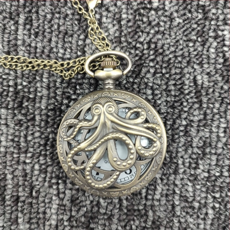 Kvarc zsebóra, fémből készült tokkal, kör alakú számlappal, üregesen faragott lokomotív motívummal, mozgásmodell 68