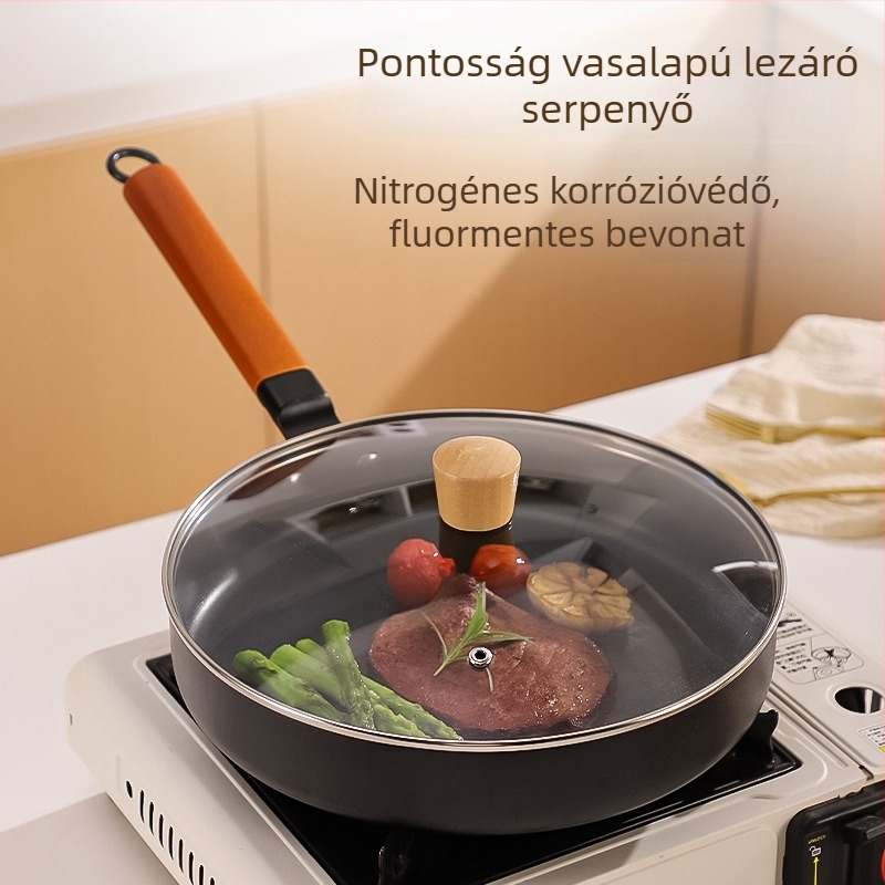 Finomvasból készült serpenyő, tapadásmentes bevonattal, kompatibilis gáztűzhellyel és indukciós főzőfelülettel, egyaljú aljzattal, üveges fedővel