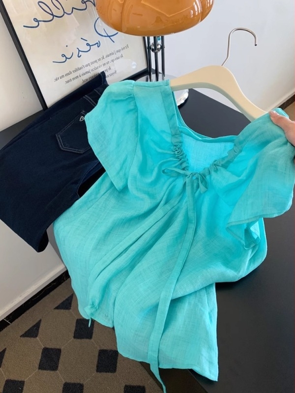 Női ing V-nyakkal, rövid ujjú, elöl fűzős záródás; fő anyag: 80–90% poliészter, ramie <30%