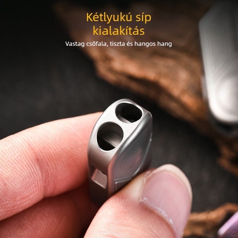 Titániumötvözetből készült túlélő síp, dupla nyílású, méretei 3.6×1.5