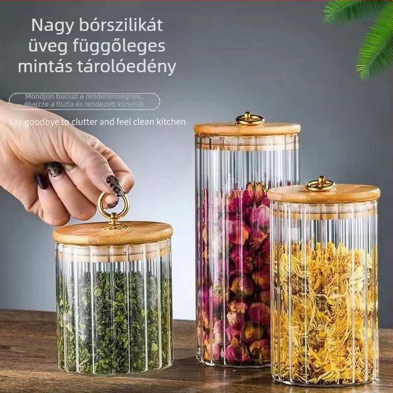 Nagy kapacitású átlátszó üveg teás tároló, kerek formájú, függőleges csíkokkal és lehúzható zárófedéllel.