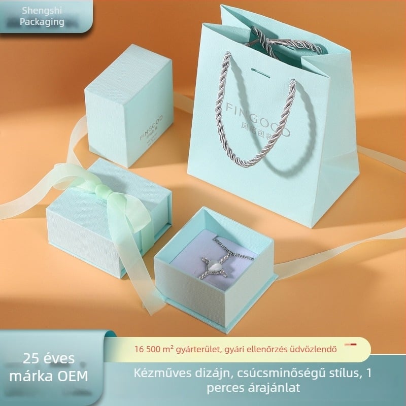 Kék masnis ékszerdoboz, magas minőségű, friss, letisztult textúrájú, fedél–alj dizájnnal gyűrűk és fülbevalók számára
