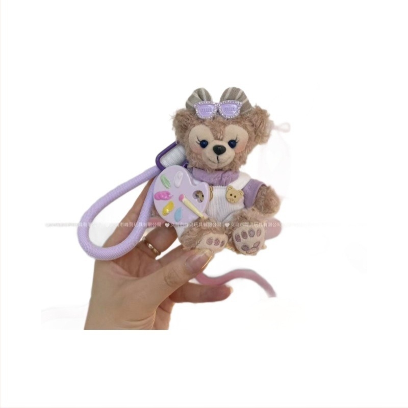 Păpușă ursuleț de pluș cu pandantiv, salopetă cu bretele și accesorii pentru îmbrăcare