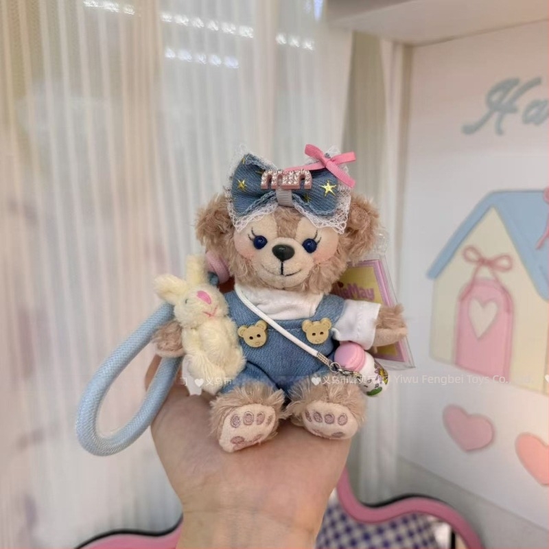 Păpușă ursuleț de pluș cu pandantiv, salopetă cu bretele și accesorii pentru îmbrăcare