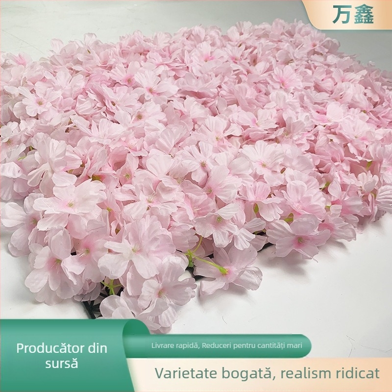 Perete floral de nuntă cu flori artificiale de cireș și hortensii, într-un șir dens de flori, ca fundal pe covor