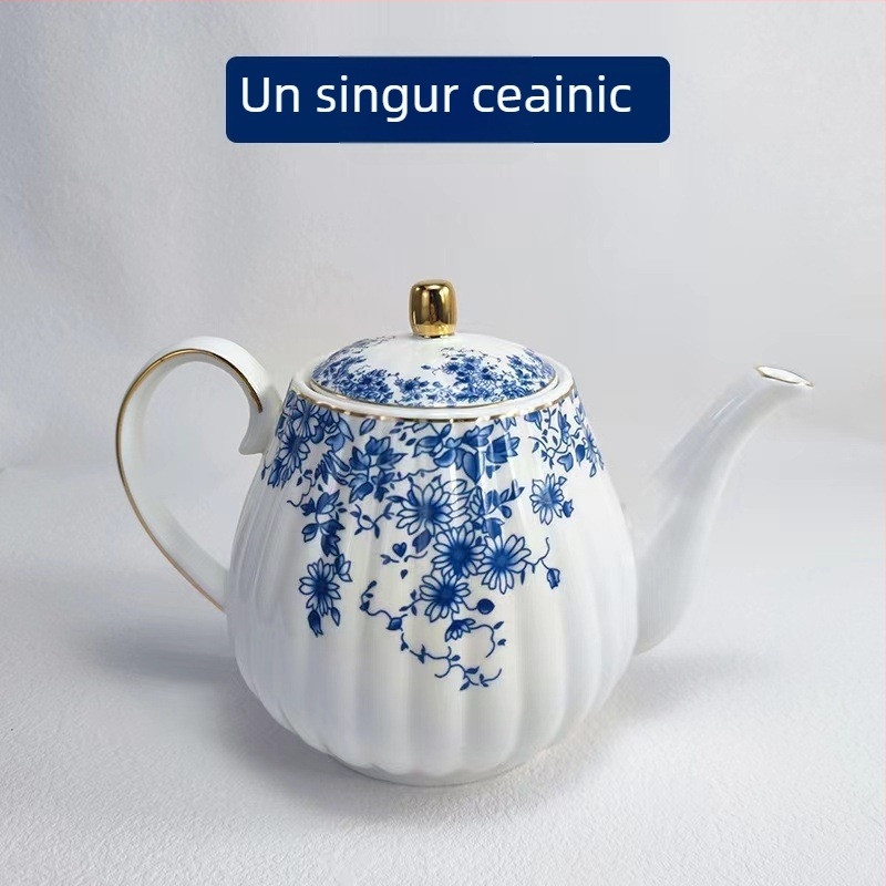Set ceai în stil englezesc cu căni ceramice încălzite și farfurioare albastre cu flori pentru ceai și cafea