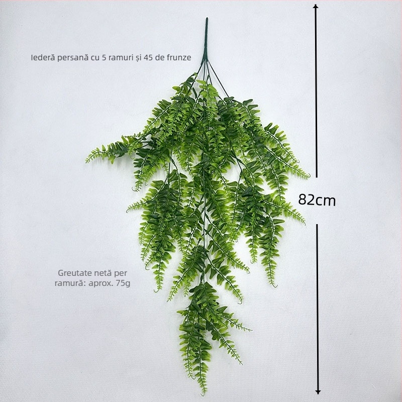 Perete cu iarbă persiană, frunze și viță artificiale, decor verde cu plantă păianjen agățată